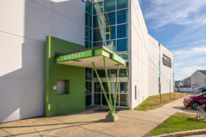 Exterior view of a Goodwill Superstore Outlet with green doors.